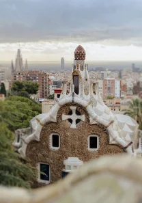 Park Güell’s mosaic rooftop overlooks Barcelona, perfect backdrop for a surprise proposal photoshoot testimonial.