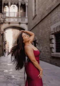 Solo photoshoot in Barcelona old town with flowing hair and red dress