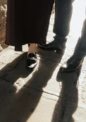 Sunlit couple’s feet and shadows on a stone path, captured during a Vacation Portraits photoshoot.