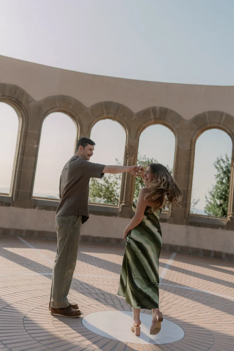 Tim twirls Megan beneath the stone arches at Montserrat.